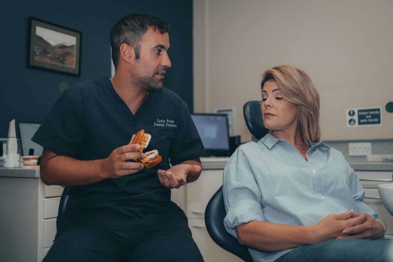Dentist talking with a patient at Lynn Road Dental Practice